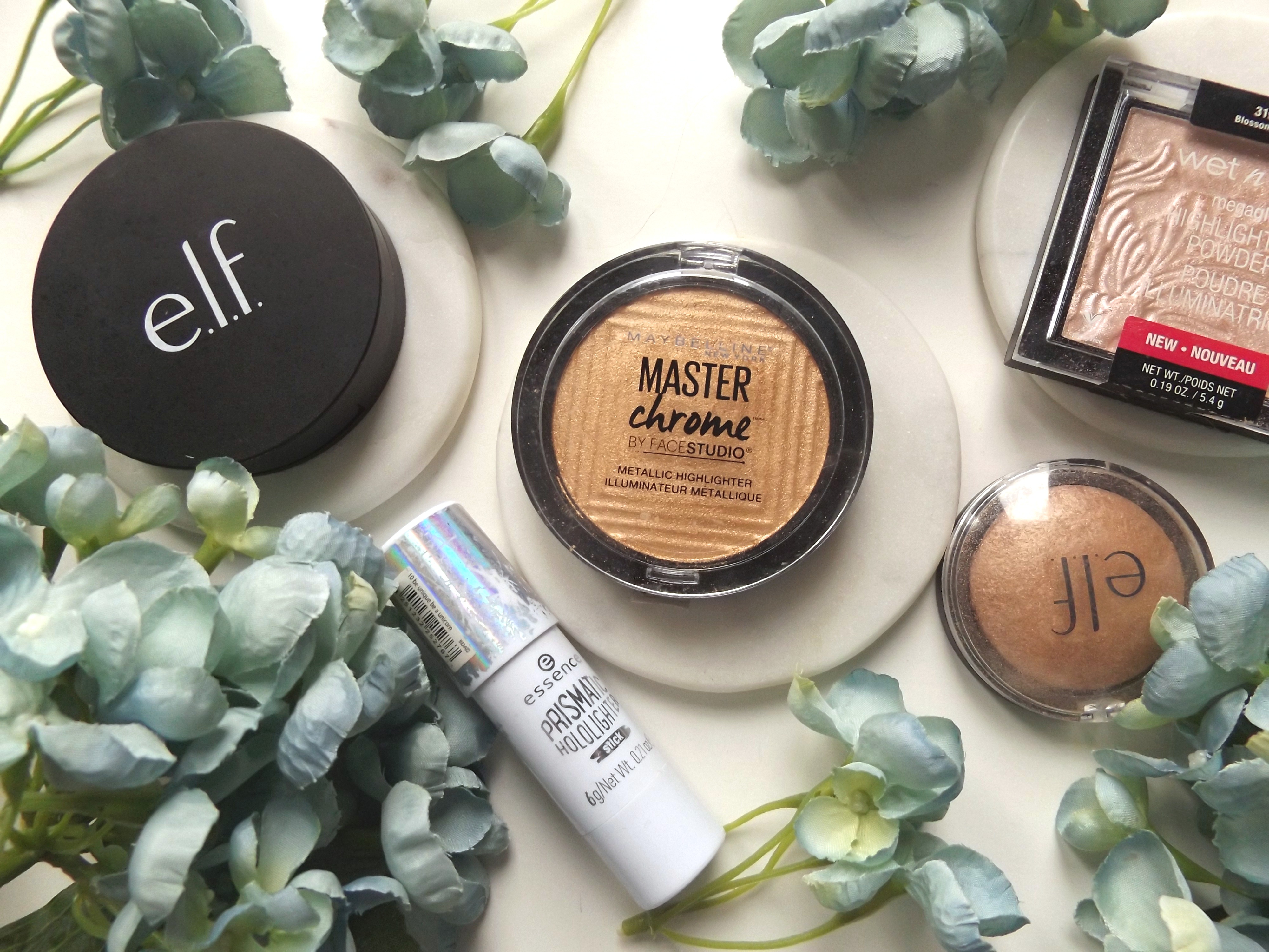 highlighter clockwise: ELF shimmering skin highlighter, essence prism highlighter, Maybelline master chrome highlighter, ELF baked highlighter in blushed gems, Wet n wild highlighter in blossom glow. 